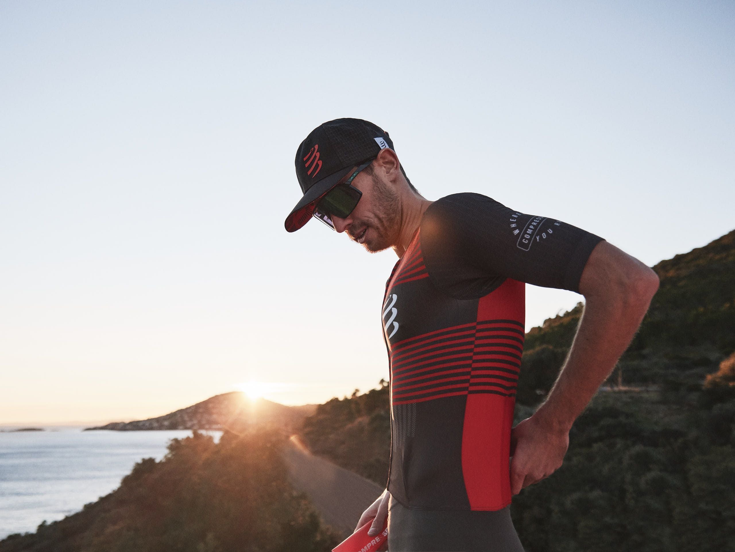 Racing Trucker Cap by Compressport in black with red logo, high-performance breathable headwear for stylish running and outdoor use