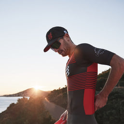 Racing Trucker Cap by Compressport in black with red logo, high-performance breathable headwear for stylish running and outdoor use
